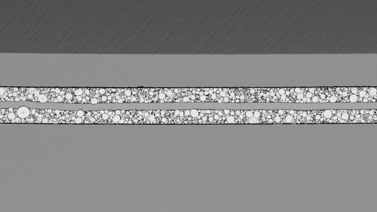 SEM image of the full Li-NMC electrode sample, showing the two porous layers and the metal film at the center of the structure.